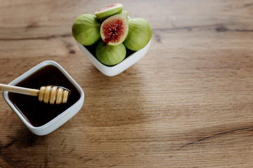 Figs and honey in a white bowl