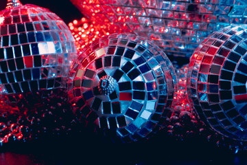 Mirror balls reflecting lights close up, nightlife background