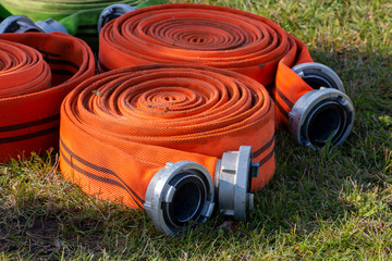 orange fire hoses in a roll to extinguish a fire