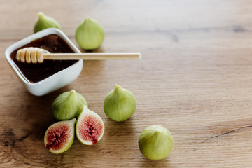 Figs and honey in a white bowl