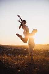 Young man toss up his woman to the sky they send Genuine emotions  to the world.