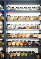 Shelf in a shop with colorful natural herbs and spices