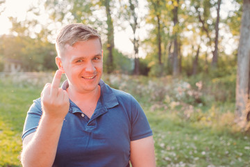 Man showing middle finger doing fuck you bad expression, provocation and rude attitude. Screaming...