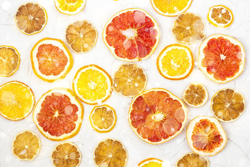 Border of Dried slices of various citrus fruits on white background. Orange lemon grapefruit with copyspace