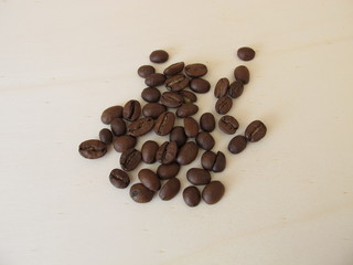 Roasted organic Arabian coffee beans on a wooden board