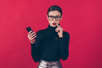 Portrait of her she nice-looking attractive trendy gorgeous pretty fashionable minded serious girl using cell app 5g isolated on maroon burgundy marsala red pastel color background