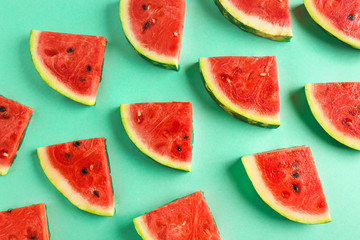 Many slices of watermelon on color background