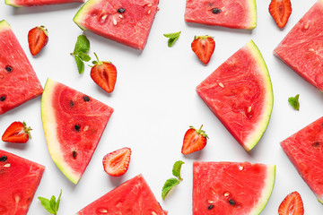 Many slices of watermelon with strawberry and mint on white background