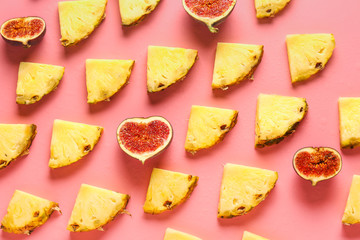 Many slices of pineapple and fig on color background