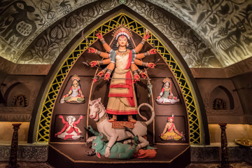 Idol of Goddess Devi Durga at a decorated puja pandal in Kolkata, West Bengal, India. Durga Puja is...