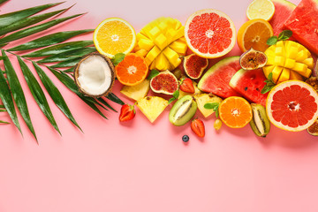 Sweet ripe fruits on color background