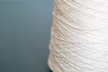White bobbins of wool yarn for hand and machine knitting close-up