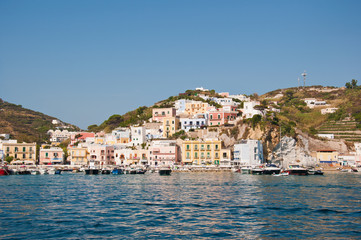 Fototapeta na wymiar Ponza island (Italy) in the summer. The islands of central Italy in Mediterranean sea. Landscape of the island of Ponza. Port of the island of Ponza. The typical colored houses of the island of Ponza.