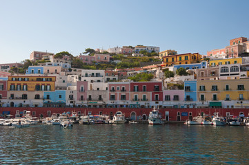 Obraz premium Ponza, Lazio / Italy - August 9 2019: port of the island of Ponza in the summer. The typical colored houses of the island of Ponza. Landscape of the harbor of island of Ponza.