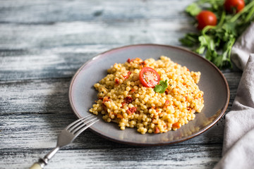 Ptitim or Birdy, Israeli pasta couscous  with tomatoes and herbs