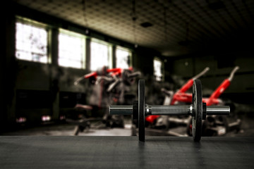 Gym interior and dumbbells on black desk with free space for your decoration. 