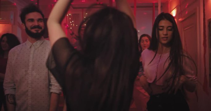 Big home party atmosphere group of young guys and ladies celebrating bury party dancing drinking and feeling good