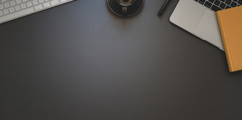 Top view of dark trendy workspace with office supplies with copy space