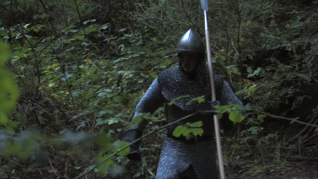 Medieval knight walks into the woods, looks around and takes a piss