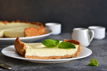 Cheesecake slice on a white plate. Close-up