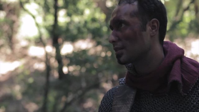 A medieval knight hit with a decapitated head