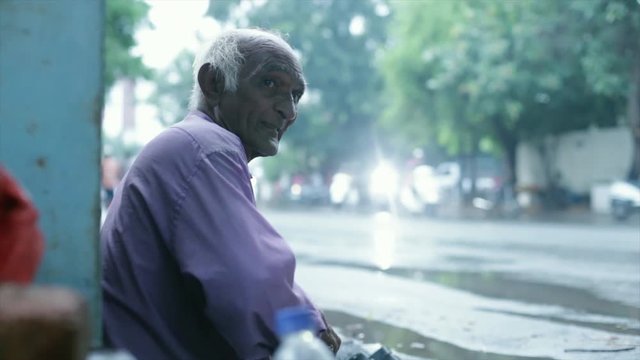 A cobbler repairing slippers of pilgrims by the roadside in the morning stock footage collection 19