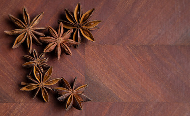 Star anise, cinnamon, nutmeg and cloves on a wooden board