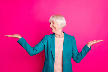 Portrait of her she nice-looking attractive cheerful cheery gray-haired lady holding invisible...