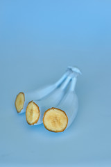 Blue bananas on a blue background. Minimal style