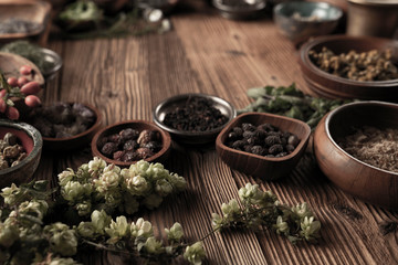 Spices theme. Collection of spices in bowls on wooden rustic table. Place for text or typography.