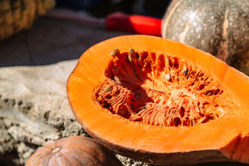 Half of orange pumpkin with seeds inside close up
