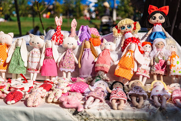 Large assortment of rag animal dolls on fall fair