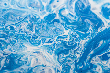 Blue and white paint mixture background