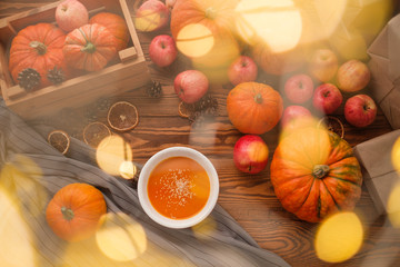 pumpkins and gift with a garland on a wooden table