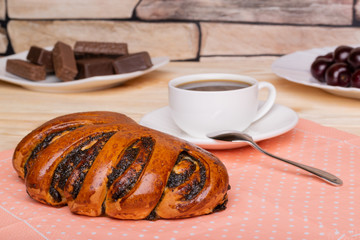 Poppy seed roll, a cup of coffee and sweetness for tasty breakfast in the morning. Homemade bake