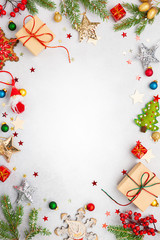 Christmas background with gift boxes, festive decor, fir tree branches and paper cards notes. Flat lay.