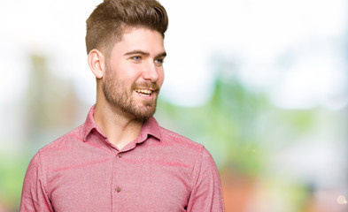 Young handsome business casual man looking away to side with smile on face, natural expression. Laughing confident.