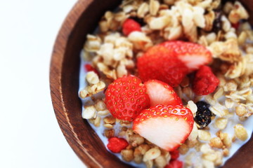 Healthy breakfast, granola in wooden bowl
