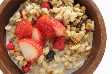 Healthy breakfast, granola in wooden bowl