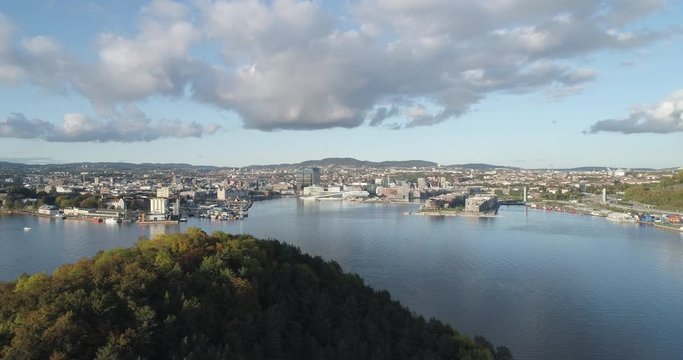 Cinema 4K drone shot with parallax motion of Hoved&oslash;ya island, the Oslofjord and the new Bj&oslash;rvika quarter project with the Lambda Edvard Munch Museum and Opera House in autumn fall, in Oslo Norway.
