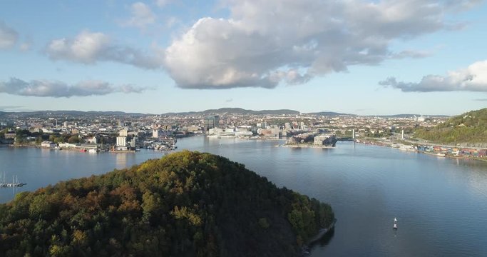 Cinema 4K drone shot with parallax motion of Hoved&oslash;ya island, the Oslofjord and the new Bj&oslash;rvika project with the Lambda Edvard Munch Museum and Oslo Opera House in autumn fall, in Oslo Norway.