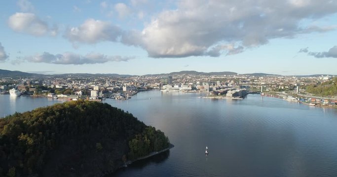 Cinema 4K drone shot with parallax motion of Hoved&oslash;ya island, the Oslofjord and the new Bj&oslash;rvika quarter project with the Lambda Edvard Munch Museum and Opera House in autumn fall, in Oslo Norway.