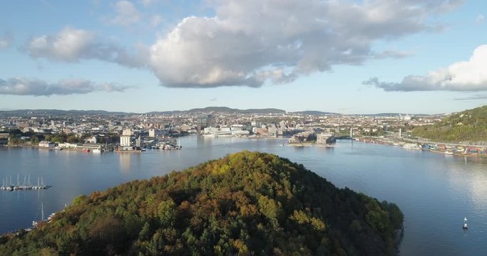 Cinema 4K drone shot with parallax motion of Hoved&oslash;ya island, the Oslofjord and the new Bj&oslash;rvika quarter project with the Lambda Edvard Munch Museum and Opera House in autumn fall, in Oslo Norway.