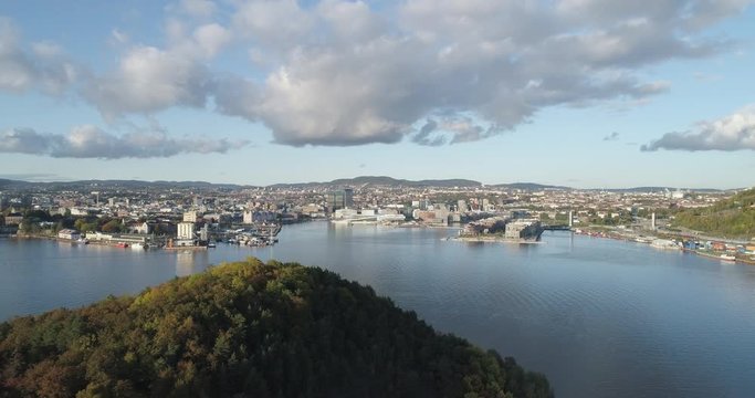 Cinema 4K drone shot with parallax motion of Hoved&oslash;ya island, the Oslofjord and the new Bj&oslash;rvika quarter project with the Lambda Edvard Munch Museum and Opera House in autumn fall, in Oslo Norway.