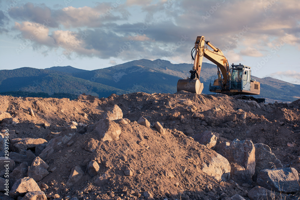 Wall mural excavator moving stone and earth