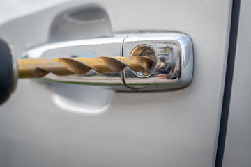 Car thief. Close - up of a man's hand opening the car with a screwdriver