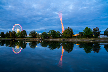 Germany, Colorful illuminated big wheel and lights of giant swabian fair called cannstatter wasen...