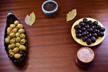 olives and spices on a black background