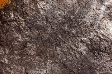 Stone background, rock wall backdrop with rough texture. Abstract, grungy and textured surface of stone material. Nature detail of rocks.
