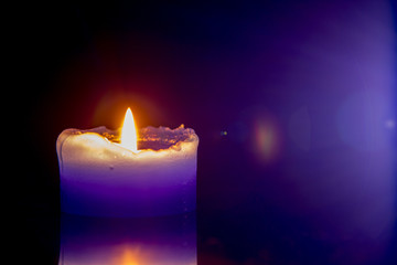 burning candle on a glass table